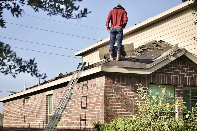 Professional roofer working on a residential roof in East Camden